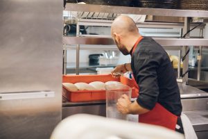 A chef making pinsa dough.